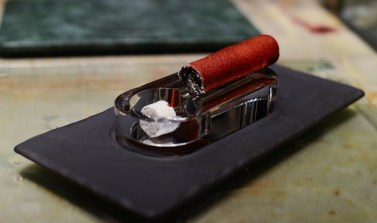 Cigar Leaf Smoked cherry root and crispy potato crust; lined with an green apple gel sheet and filled with cucumber black sesame ash